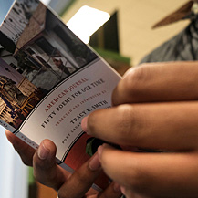 An audience member receives a free copy of "American Journal" for attending Tracy K. Smith’s "American Conversations" event at the South Lafourche Public Library in Cut Off, LA. December 15, 2018. Credit: Kevin Rabalais.